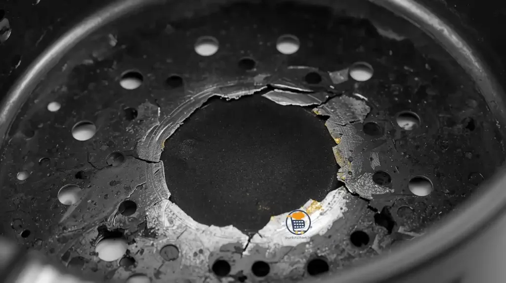 Close-up macro photograph of damaged air fryer basket showing significant peeling, flaking, and separation of PTFE non-stick coating with exposed metal oxidation 